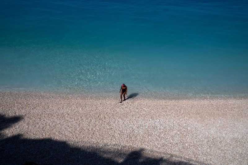 &copy; Reuters. FILE PHOTO: A woman on Porto Katsiki beach on the island of Lefkada, Greece