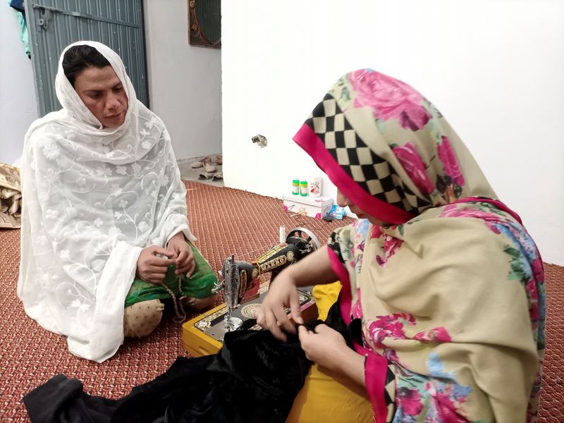 &copy; Reuters. Rani Khan looks at one of her students during a tailoring lesson in Islamabad