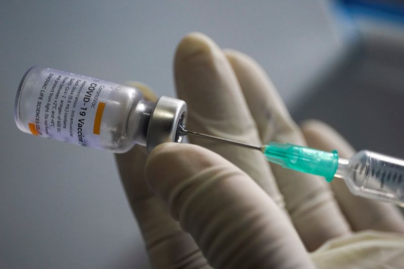 &copy; Reuters. IMAGEN DE ARCHIVO. Un trabajador de salud sostiene una jeringa y un vial de la vacuna de Sinovac contra la enfermedad del coronavirus (COVID-19) en un mercado después de que cientos de residentes locales en el distrito dieron positivo por COVID-19 en Ban