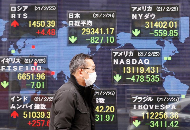 &copy; Reuters. A man walks past a stock quotation board at a brokerage in Tokyo