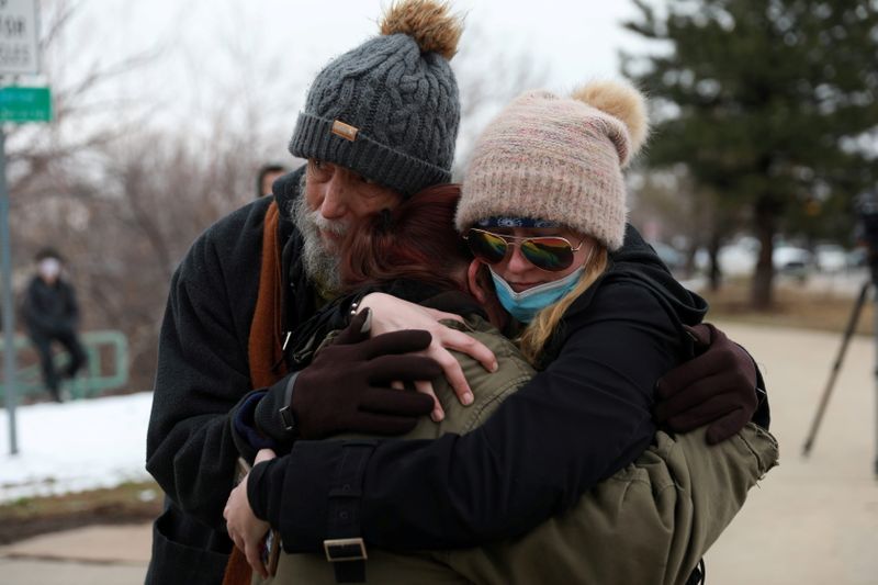 © Reuters. Sarah Moonshadow is comforted by David and Maggie Talley after Moonshadow was inside King Soopers grocery store during a shooting in Boulder