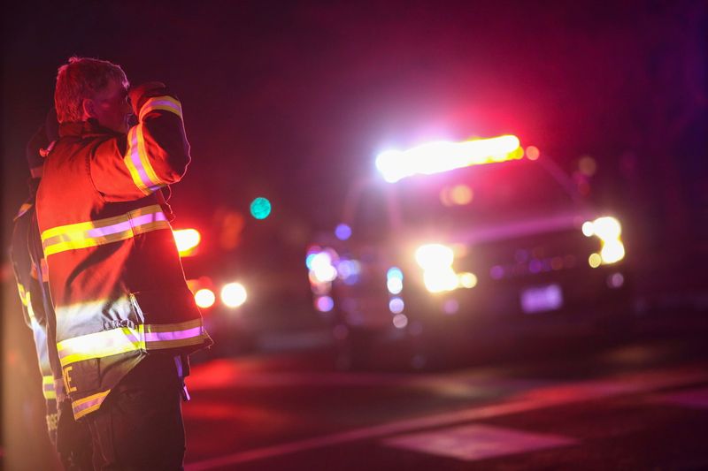 © Reuters. First responders stand in salute as a procession of law enforcement vehicles drive past in honor of fallen Boulder police officer Eric Talley, who was shot and killed by a gunman at a King Soopers grocery store in Boulder