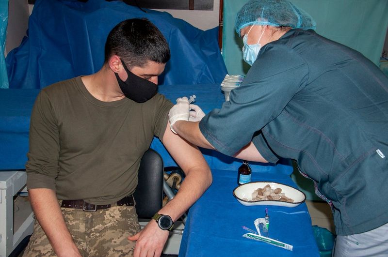 &copy; Reuters. A Ukrainian serviceman receives a dose of the Oxford-AstraZeneca vaccine in Donetsk Region