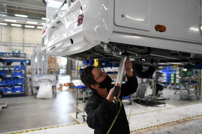 © Reuters. FILE PHOTO: Worker assembles a vehicle at the Knaus-Tabbert AG factory in Jandelsbrunn