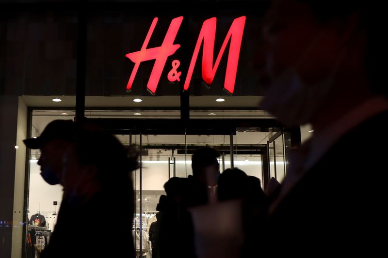 © Reuters. People walk past an H&M store at a shopping mall in Beijing