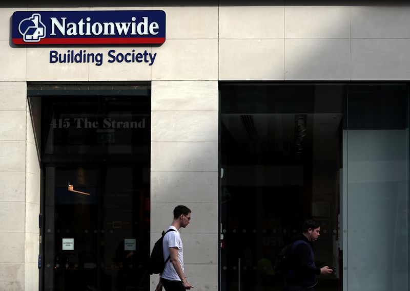 &copy; Reuters. FILE PHOTO: A man walks past a Nationwide Building Society in London