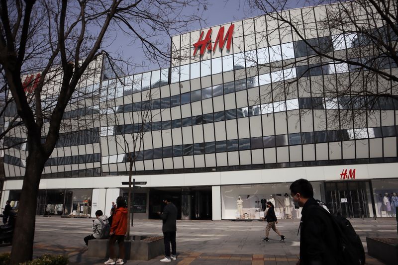 &copy; Reuters. People walk past an H&amp;M store at a shopping complex in Beijing