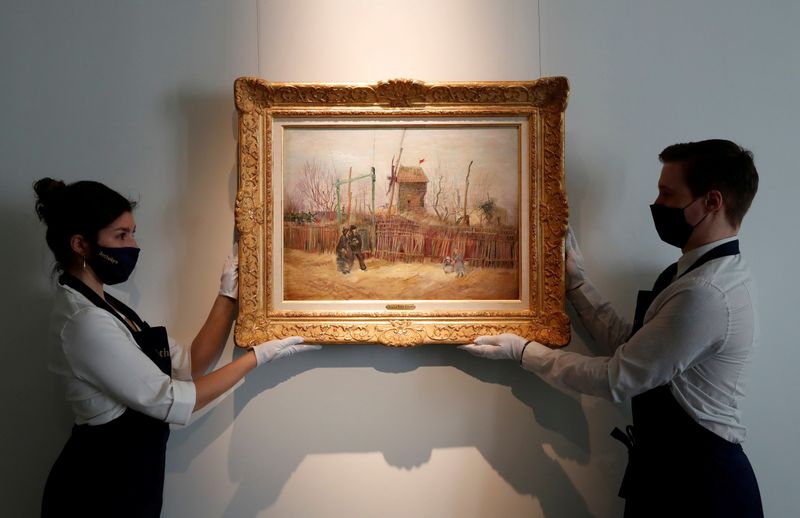 &copy; Reuters. FILE PHOTO: Sotheby&apos;s Paris employees pose with the painting &quot;Scene de rue a Montmartre&quot; by Dutch painter Vincent Van Gogh