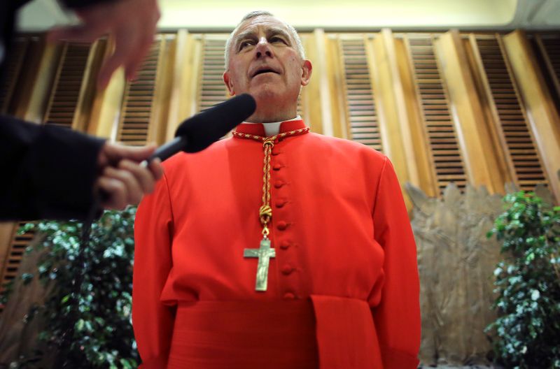 © Reuters. FILE PHOTO: Newly elevated Cardinal John Atcherley Dew speaks with journalist after taking part in the Consistory at the Vatican