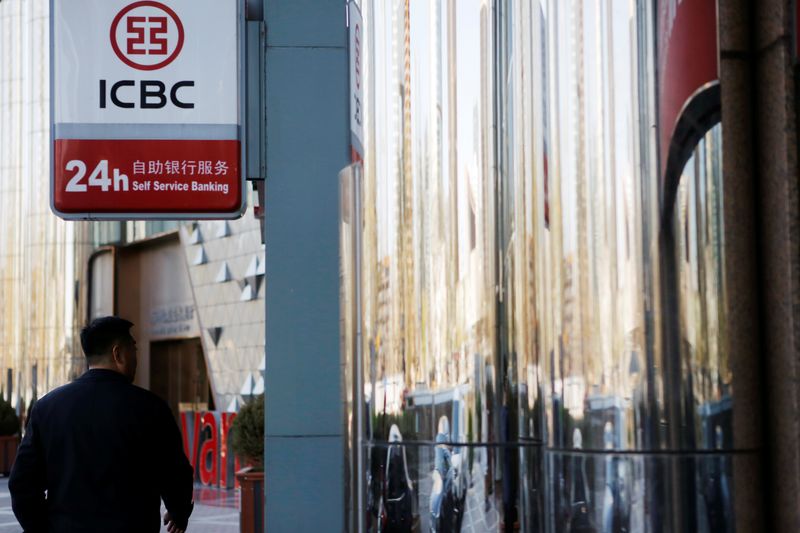 &copy; Reuters. Man walks past a branch of Industrial and Commercial Bank of China (ICBC) in Beijing