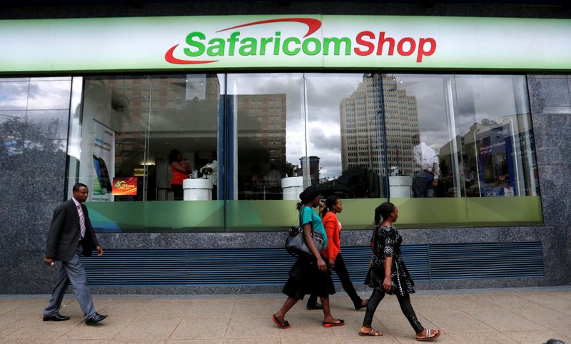 &copy; Reuters. FILE PHOTO: Pedestrians walk past a mobile phone care centre operated by Kenyan&apos;s telecom operator Safaricom in the central business district of Kenya&apos;s capital Nairobi