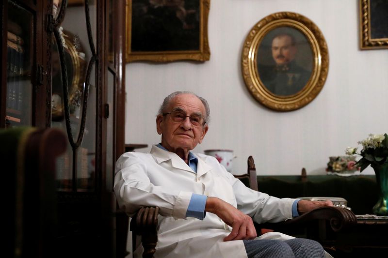 &copy; Reuters. Kormendi, 97-year-old doctor, poses for a picture in his doctor&apos;s office at his home in Budapest