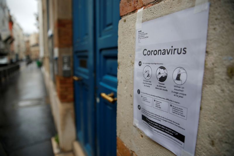 &copy; Reuters. FILE PHOTO: A placard with information about the coronavirus is displayed in front of a school in Paris