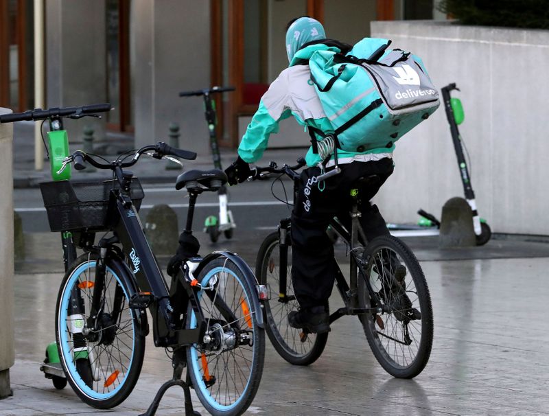 &copy; Reuters. FILE PHOTO: A courier for food delivery service Deliveroo rides a bike in central Brussels
