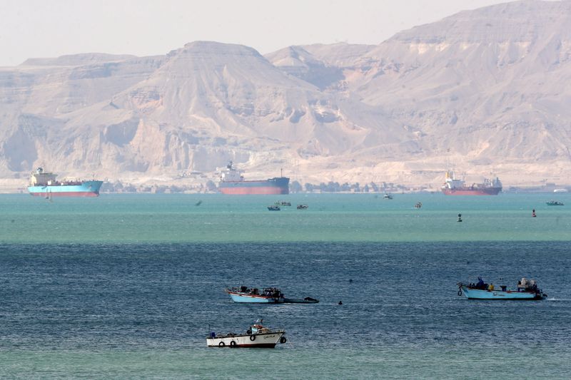 Tugs, dredgers still struggle to free ship blocking Suez Canal