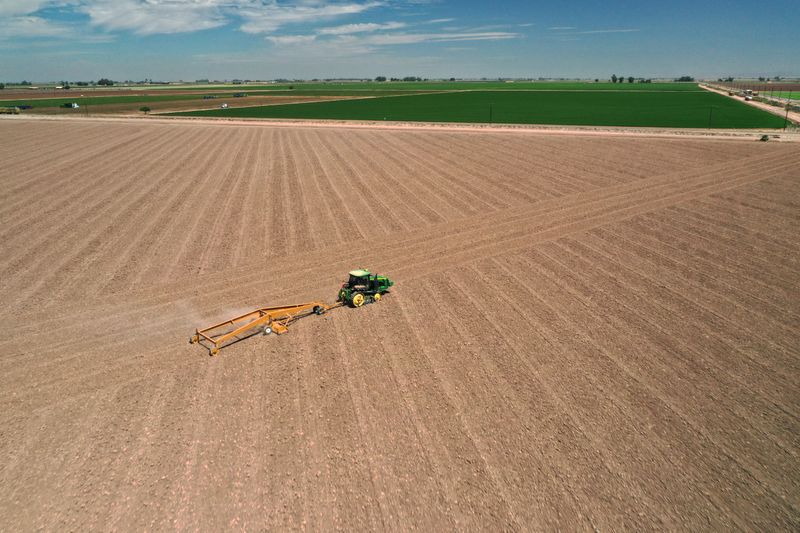 &copy; Reuters. A tractor tills dusty farmland as the spread of the coronavirus disease (COVID-19) continues in this aerial photo taken over Holtville, California