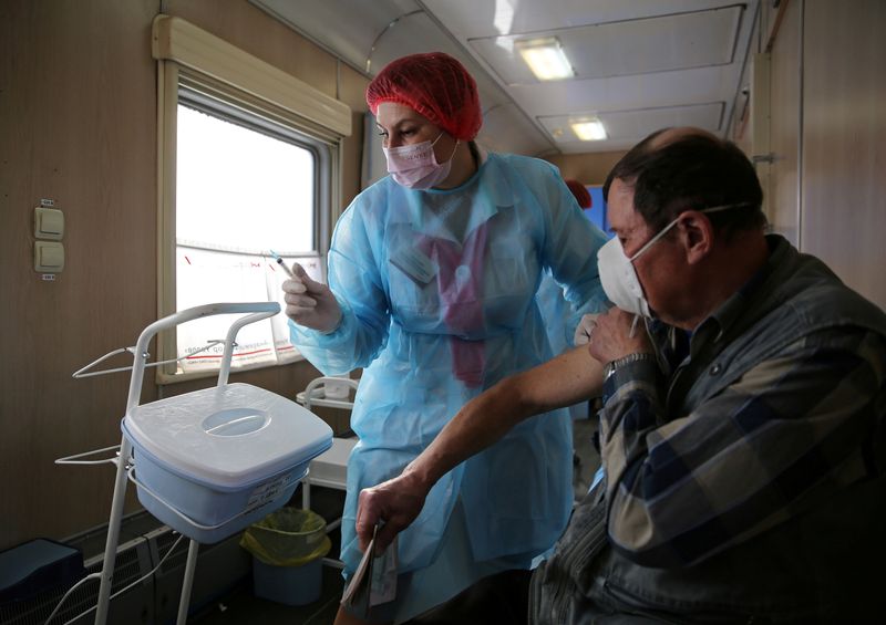 &copy; Reuters. Homem recebe dose da vacina Sputnik V cntra a Covid-19 em trem médico em Tulun, Rússia