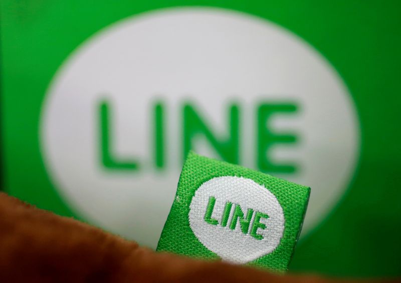 &copy; Reuters. FILE PHOTO: The logo of free messaging app Line is pictured on a smartphone and the company&apos;s stuffed toy in this photo illustration taken in Tokyo