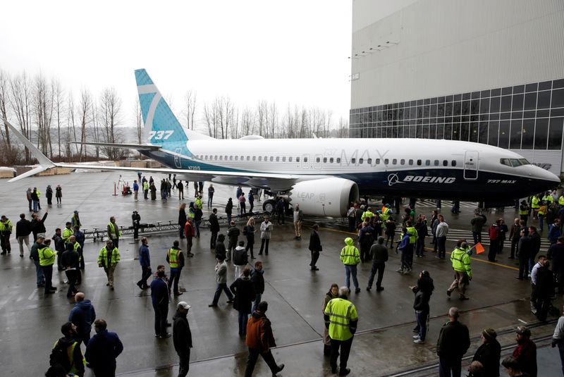 © Reuters. FILE PHOTO: Employees are pictured as the first Boeing 737 MAX 7 is unveiled in Renton