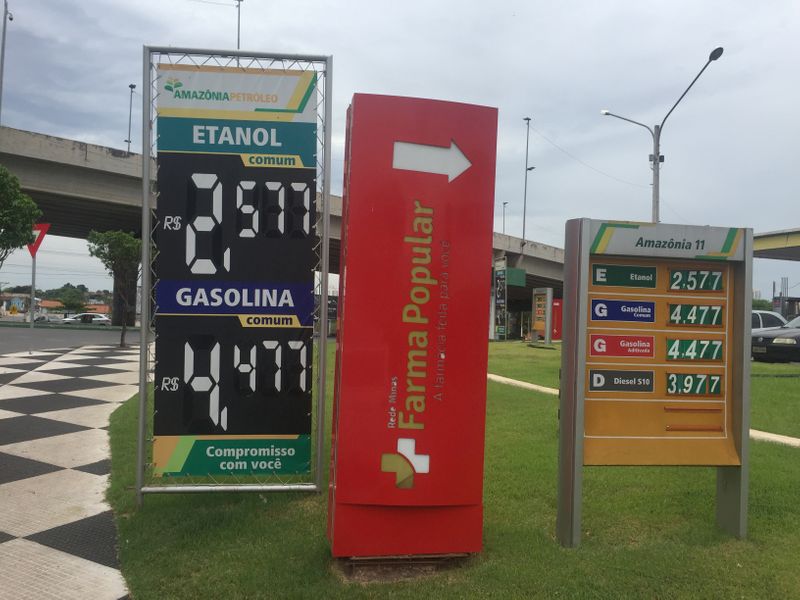 © Reuters. FILE PHOTO: A placard shows prices for ethanol and gasoline at a gas station in Cuiaba