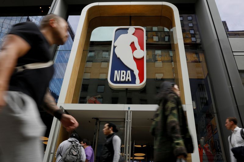 &copy; Reuters. FILE PHOTO: The NBA logo is displayed as people pass by the NBA Store in New York