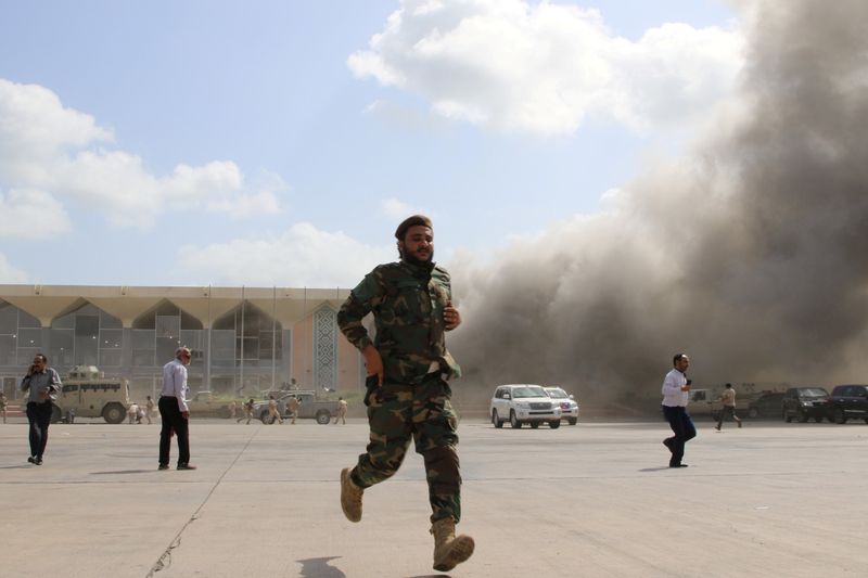 &copy; Reuters. FILE PHOTO: Security personnel and people react during an attack on Aden airport moments after a plane landed carrying a newly formed cabinet for government-held parts of Yemen, in Aden