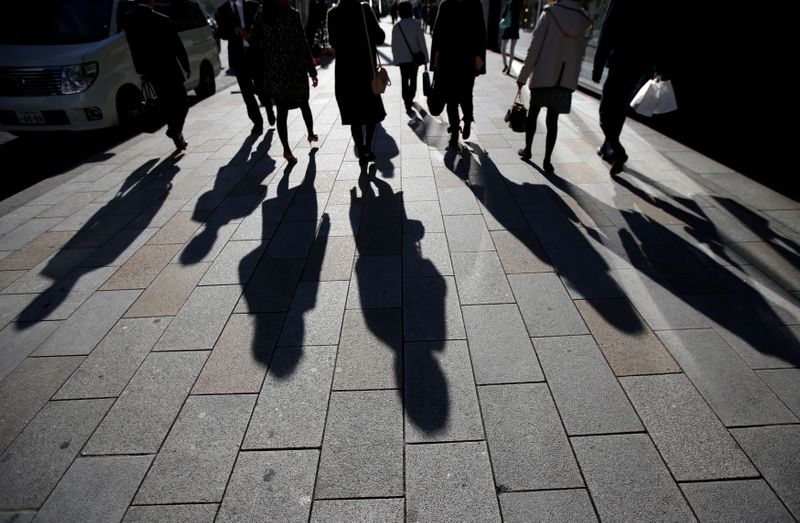 &copy; Reuters. FILE PHOTO: Shadows of pedestrians are pictured cast on a street in Tokyo