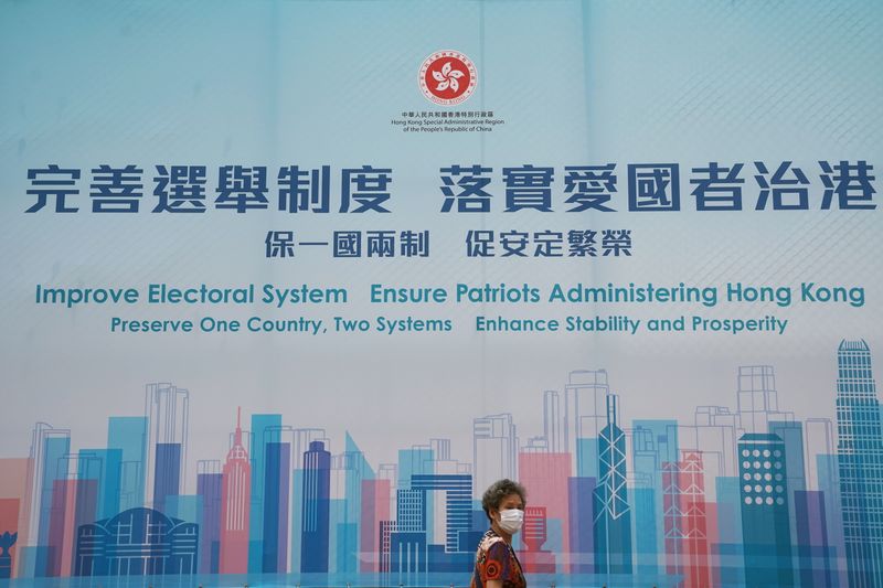 &copy; Reuters. Woman walks past a government advertisement promoting Hong Kong electoral reforms