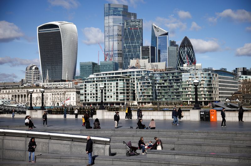 &copy; Reuters. FILE PHOTO: The City of London financial district can be seen as people walk along the south side of the River Thames, amid the coronavirus disease (COVID-19) outbreak in London