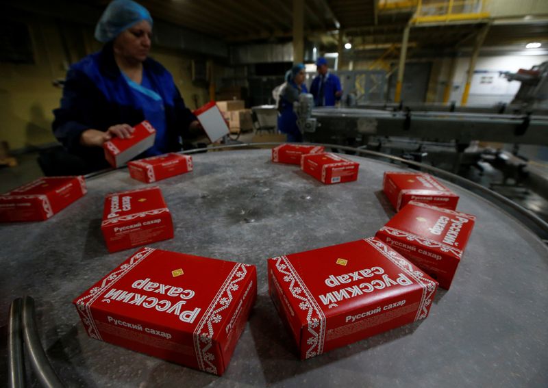 &copy; Reuters. An employee sorts packages with refined sugar at Znamensky Sugar Plant, owned by Russian farming conglomerate Rusagro, in the settlement of Znamenka