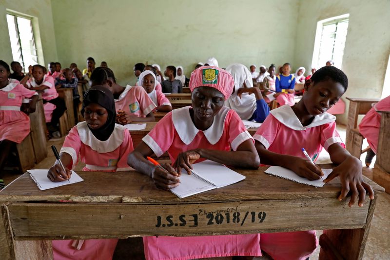 &copy; Reuters. The Wider Image: It&apos;s never too late to learn says 50-year-old Nigerian school pupil