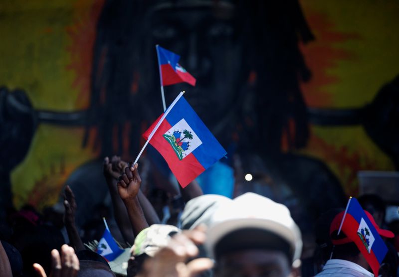 &copy; Reuters. Demonstrators hold Haiti&apos;s national flags during a protest against the government of President Jovenel Moise, in Port-au-Prince