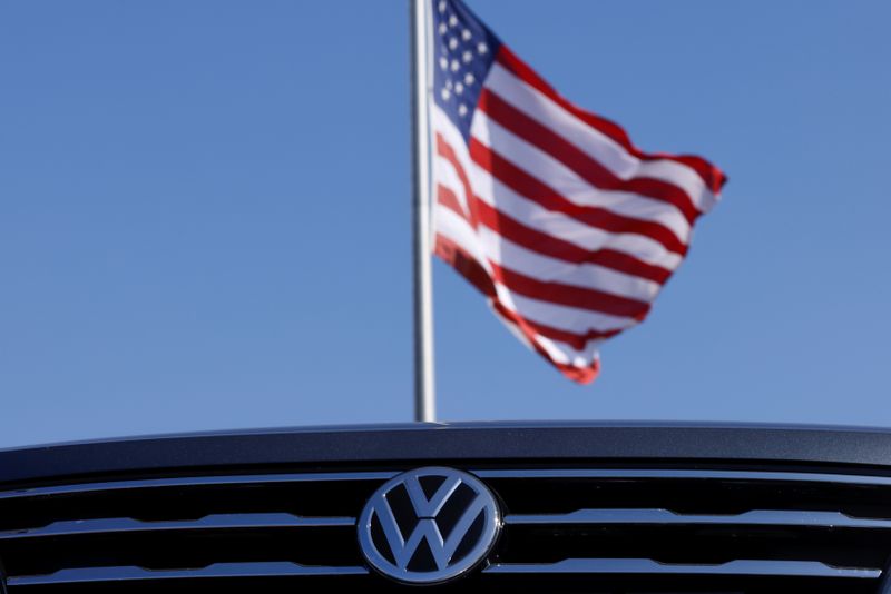&copy; Reuters. Volkswagen logo and American flag are shown at car dealershio in California