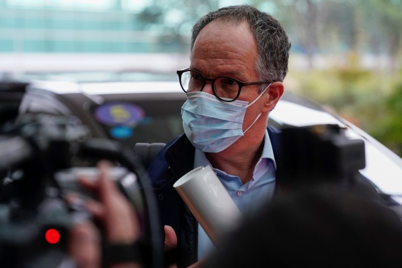 &copy; Reuters. A member of the World Health Organisation (WHO) arrives at the airport in Wuhan