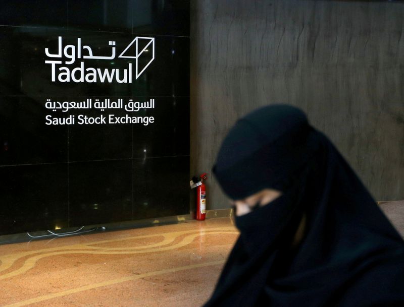 &copy; Reuters. FILE PHOTO: Saudi woman walks at the Saudi stock market (Tadawul), in Riyadh