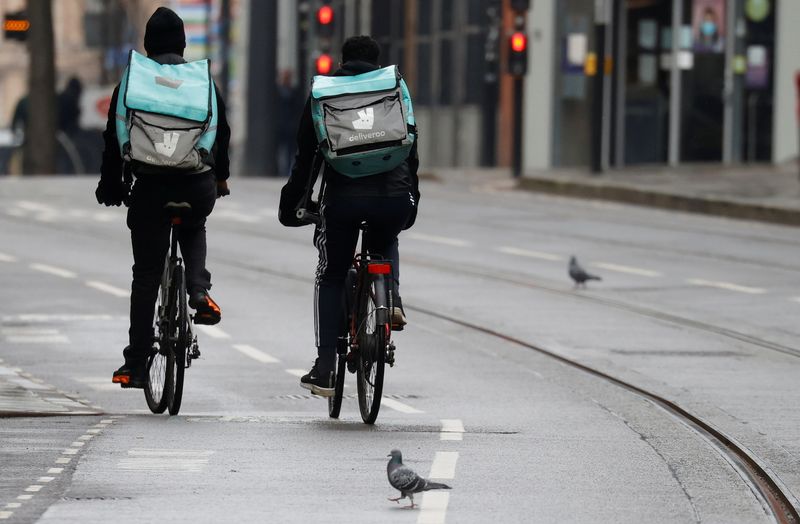 &copy; Reuters. Deliveroo delivery drivers cycle through the centre of Manchester