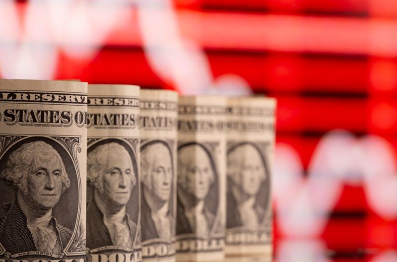 &copy; Reuters. FILE PHOTO: U.S. one dollar banknotes are seen in front of displayed stock graph