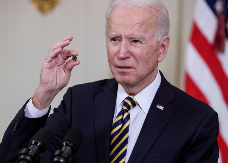 © Reuters. FILE PHOTO: U.S. President Joe Biden holds a chip as he speaks prior to signing an executive order aimed at addressing a global semiconductor shortage