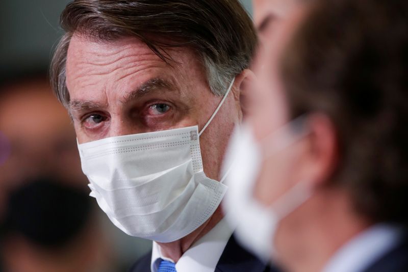 &copy; Reuters. Brazil&apos;s President Jair Bolsonaro walks to give a statement about the emergency financial aid by the federal government during coronavirus disease (COVID-19) crisis at the Planalto Palace in Brasilia