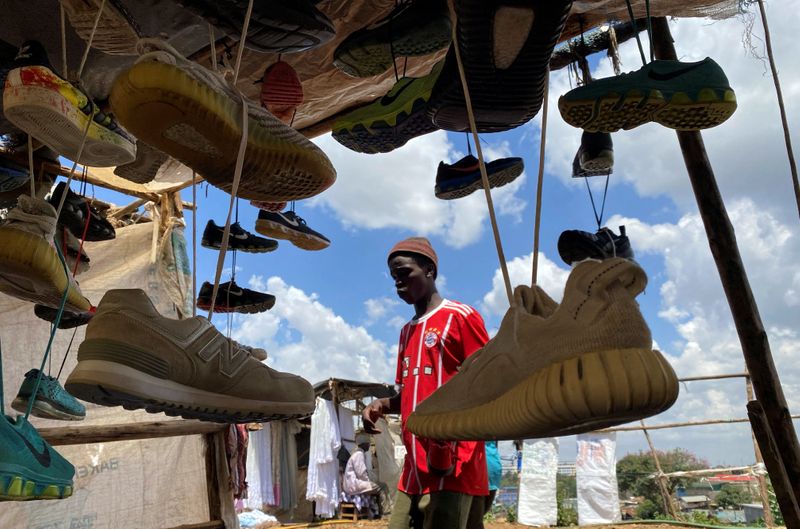 &copy; Reuters. FILE PHOTO: A vendor arranges second-hand shoes for sale at an open stall during Good Friday, after the government banned gatherings amid concerns about the spread of COVID-19 at the Kibera slums in Nairobi