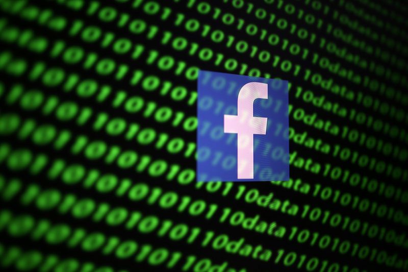 &copy; Reuters. The Facebook logo and binary cyber codes are seen in this illustration