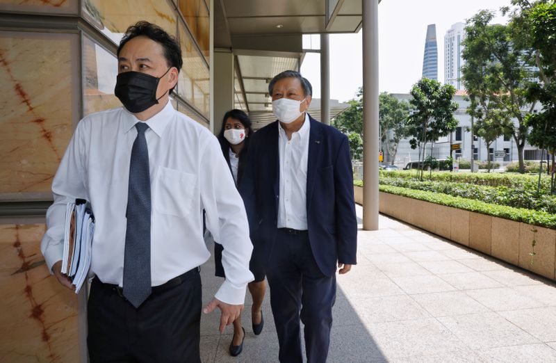 &copy; Reuters. FILE PHOTO: Financial adviser and blogger Leong Sze Hian along with his lawyer Lim Tean, leave the High Court on the first day of their defamation hearing, in Singapore