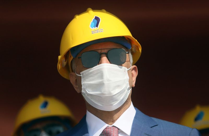 &copy; Reuters. Iraq&apos;s Prime Minister Mustafa al-Kadhimi looks on as he wears a face mask at the central station gas processing plant at Rumaila oilfield in Basra