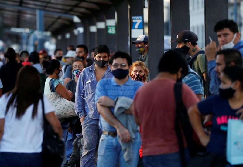 &copy; Reuters. FILE PHOTO: People wearing faces mask as a protection against the coronavirus disease (COVID-19) wait for the bus, in Buenos Aires