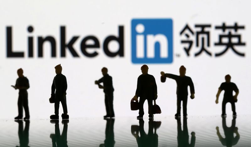 &copy; Reuters. Small toy figures are seen between displayed U.S. flag and Linkedin logo in this illustration picture