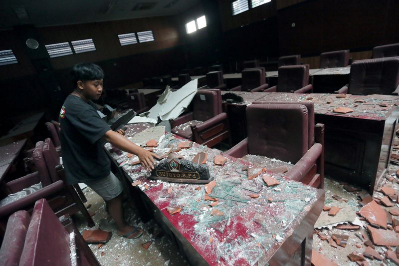 &copy; Reuters. A man cleans up a damaged courtroom affected by an earthquake of magnitude 5.9 struck in the ocean 91 km (57 miles) south-southeast of Blitar
