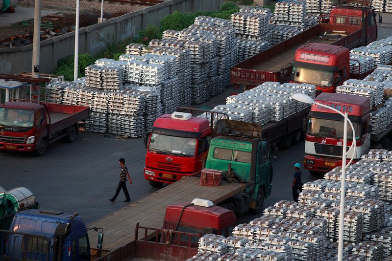 &copy; Reuters. Trabajadores junto a un depósito de lingotes de aluminio en Wuxi, provincia de Jiangsu