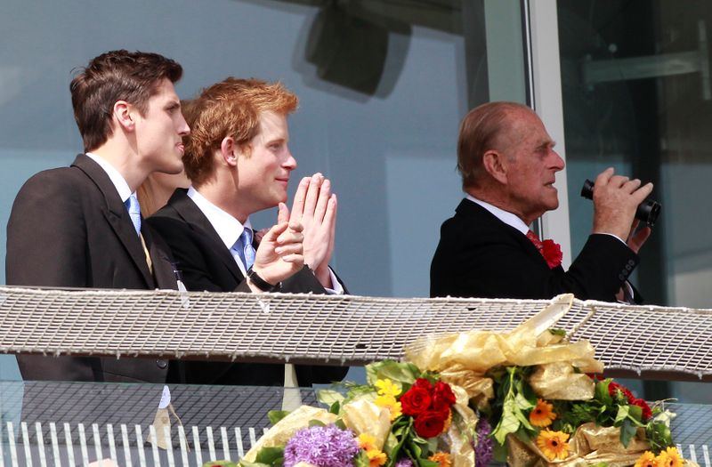 © Reuters. FILE PHOTO: Britain's Prince Harry and Prince Philip watch the 3:15 race at Epsom Racecourse in southern England