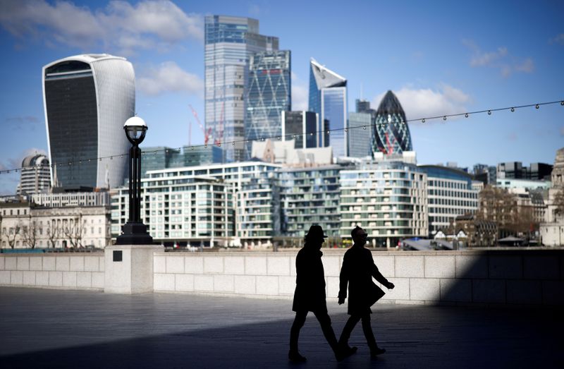 &copy; Reuters. FILE PHOTO: The City of London financial district can be seen as people walk along the south side of the River Thames, amid the coronavirus disease (COVID-19) outbreak in London