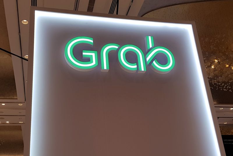 &copy; Reuters. FILE PHOTO: A Grab logo is pictured at the Money 20/20 Asia Fintech Trade Show in Singapore